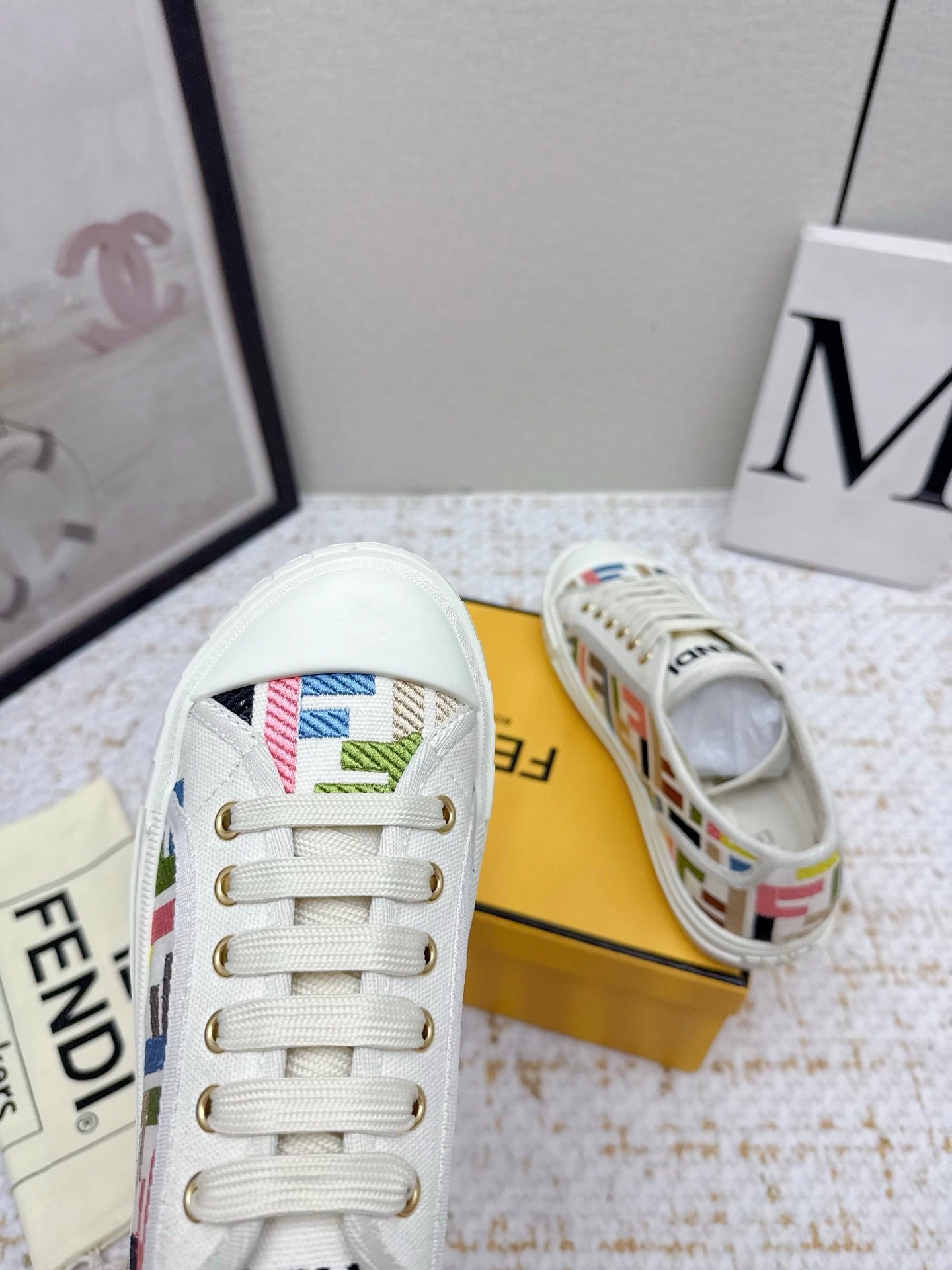 Fendi low-top sneakers close-up with white leather trim and colorful logo details