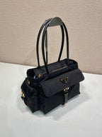Prada black tote bag with side flap pocket, shoulder strap, and logo badge