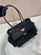 Prada black tote bag angled view with front flap pocket and top handles