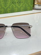 Gucci sunglasses with gold frame and tinted lenses, side profile detail.