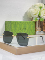 Gucci sunglasses with gold-tone frame and dark lenses, angled view.