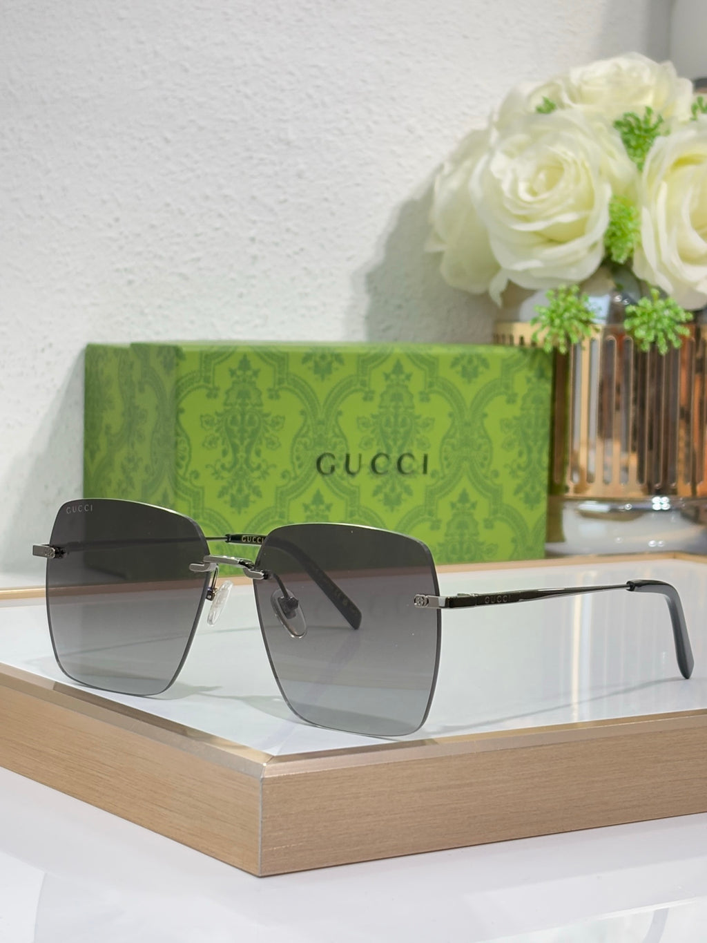 Gucci sunglasses with gold-tone frame and gradient lenses, side angle.