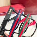 Set of Gucci eyeglasses with dark frames and colorful temples: red, blue, and green.
