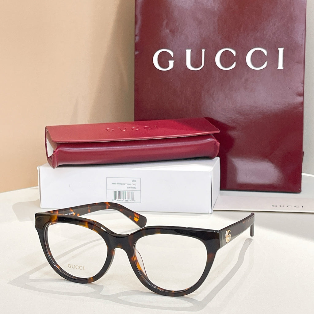 Black eyeglasses with clear lenses and tortoise-style temples, Gucci hardware