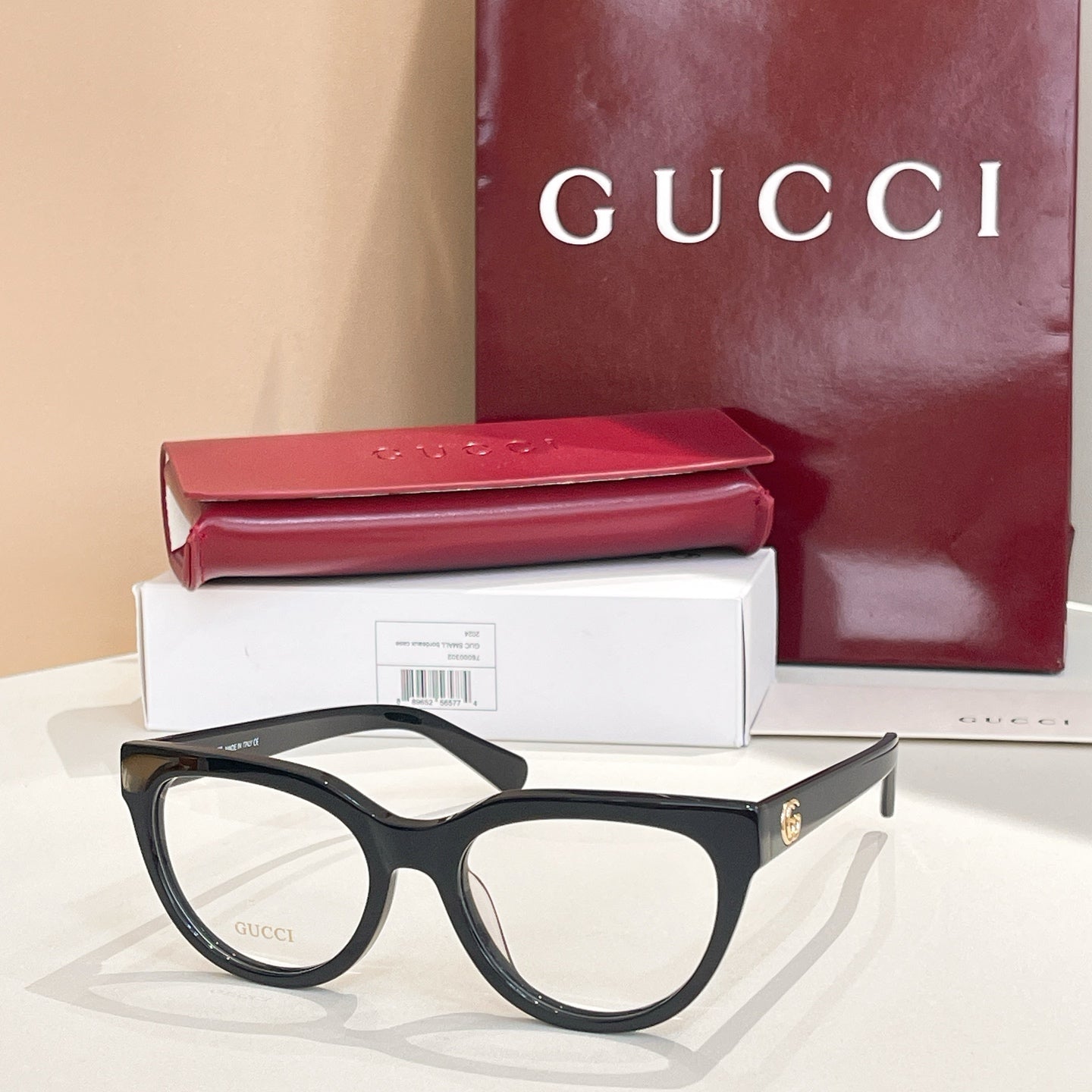 Black eyeglasses with clear lenses and slim side arms, Gucci hardware