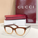 Brown tortoise eyeglasses with clear lenses and gold-tone Gucci hardware