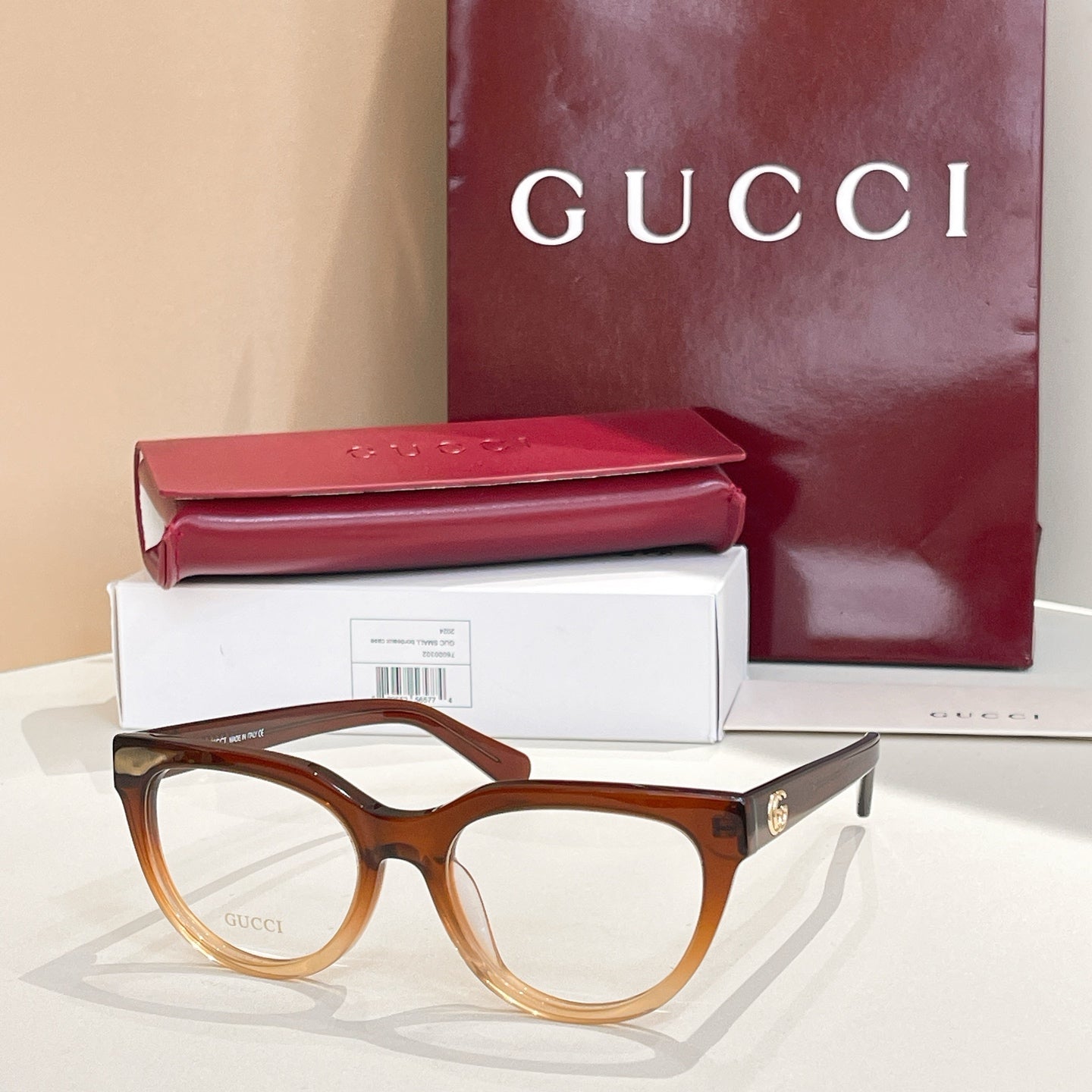 Brown tortoise eyeglasses with clear lenses and gold-tone Gucci hardware
