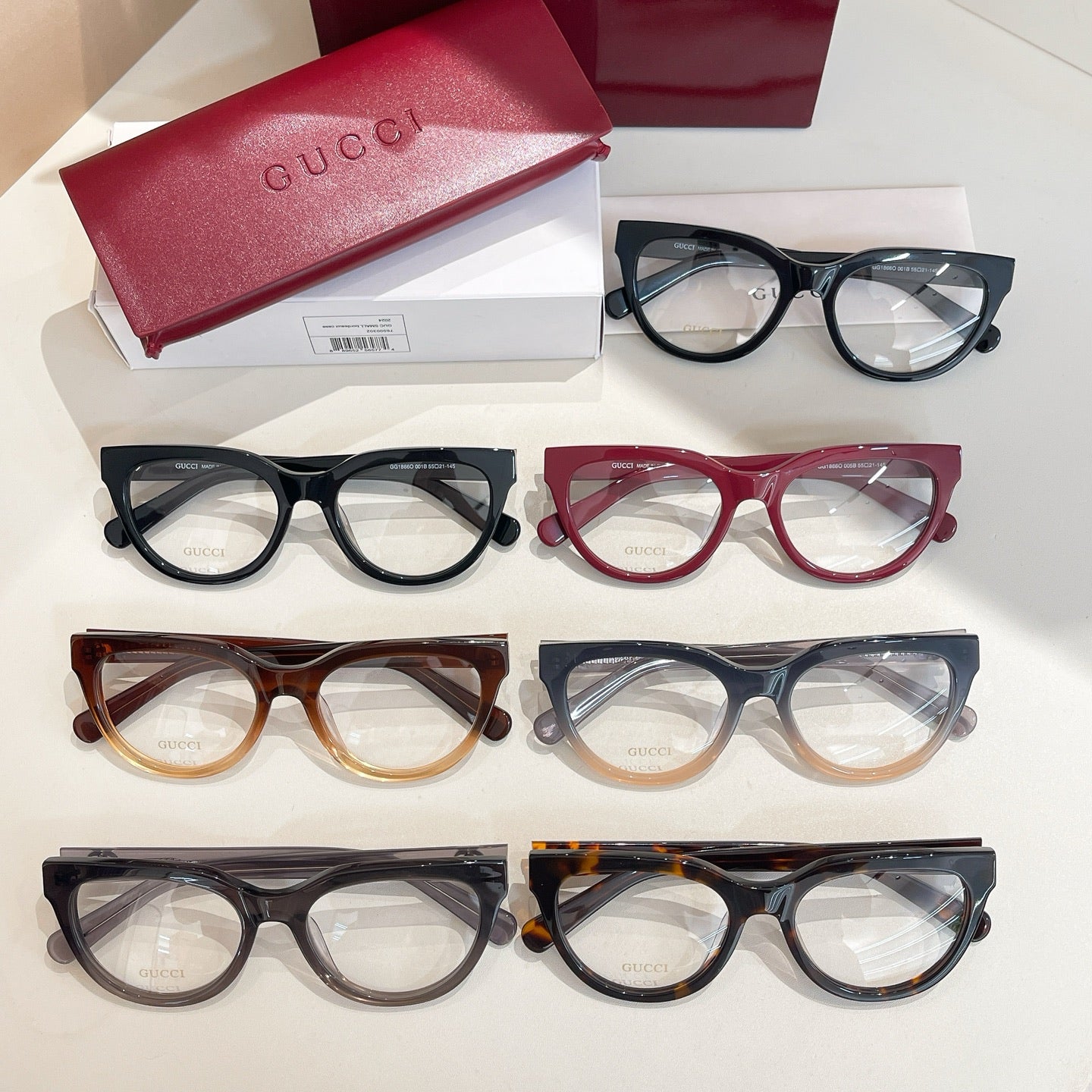 Set of seven Gucci eyeglasses with clear lenses in dark, red, and tortoise tones