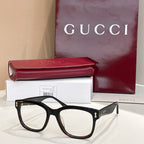 Gucci glasses with black rectangular frames, clear lenses, gold temple accents