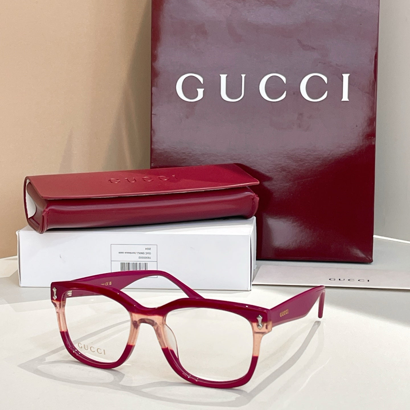 Gucci glasses with burgundy rectangular frames and clear lenses