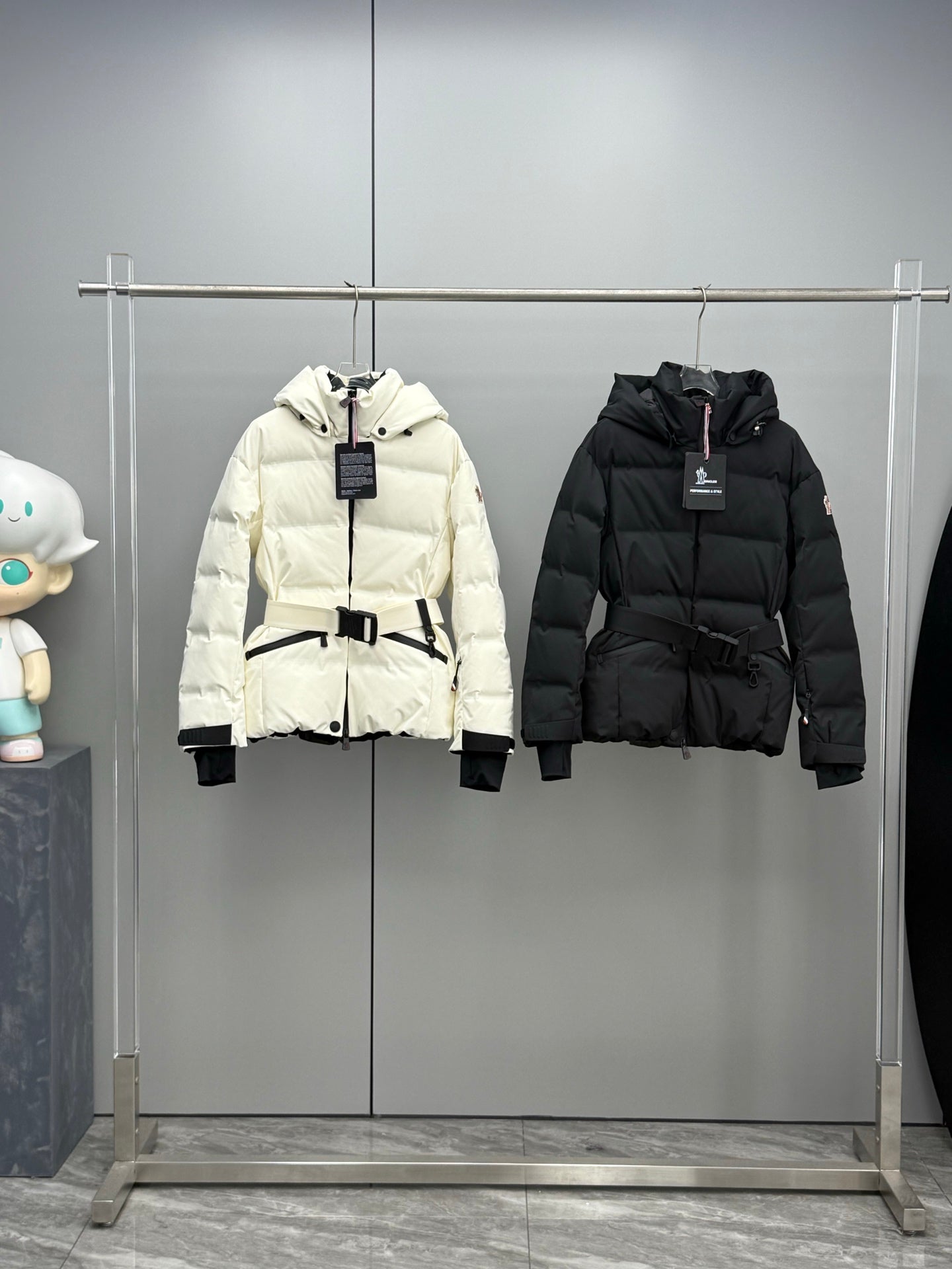 White hooded long puffer jacket with front zipper and black belt detail