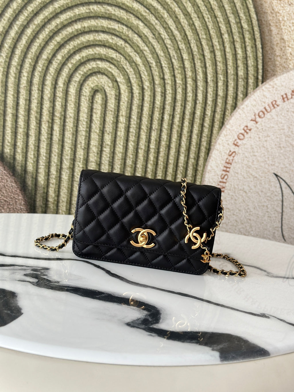 Quilted Chanel shoulder bag in black with gold-tone CC clasp and chain strap