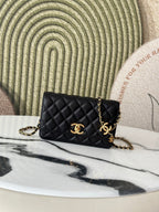 Quilted Chanel shoulder bag in black with gold-tone CC clasp and chain strap