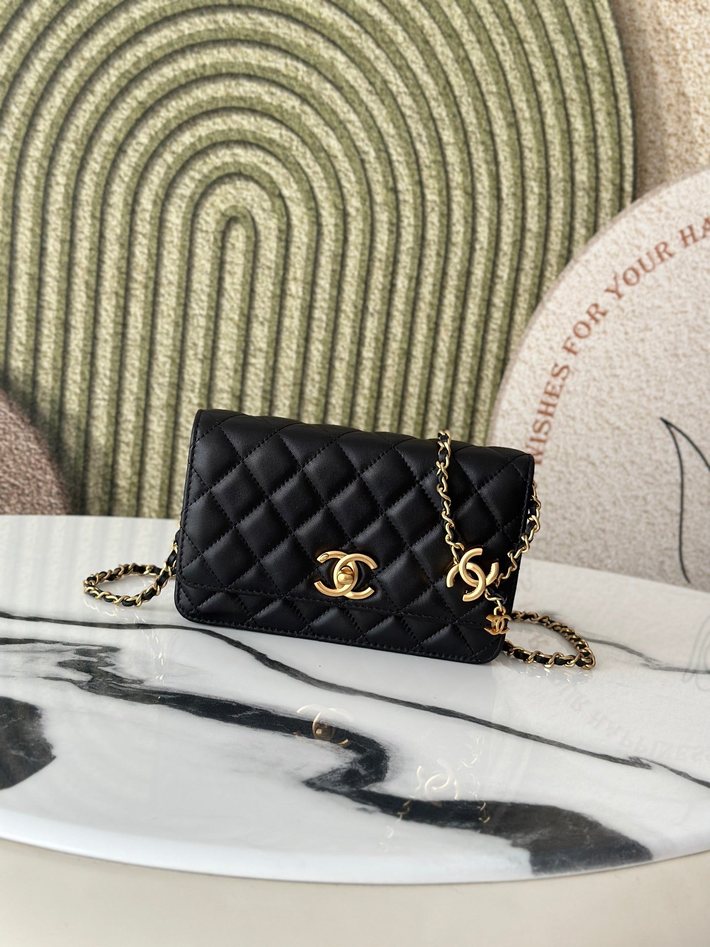 Quilted Chanel shoulder bag in black with gold-tone CC clasp and chain strap