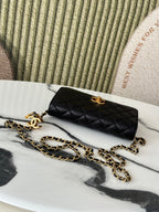 Black Chanel shoulder bag with quilted pattern and gold-tone turn-lock clasp