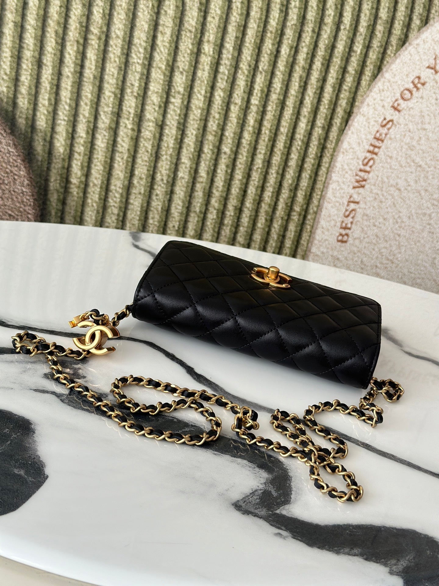 Black Chanel shoulder bag with quilted pattern and gold-tone turn-lock clasp