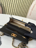Open Chanel black bag showing interior compartments and gold-tone hardware