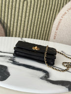 Folded Chanel black shoulder bag with gold-tone clasp and chain strap