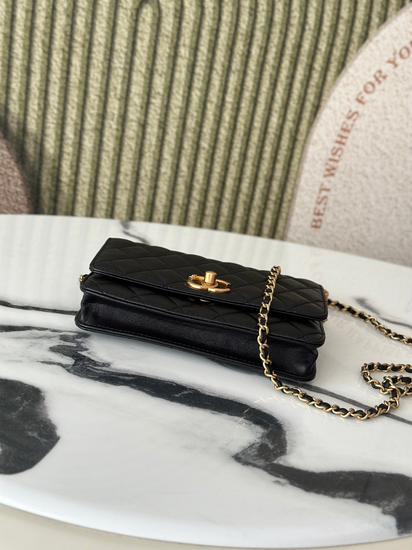 Folded Chanel black shoulder bag with gold-tone clasp and chain strap