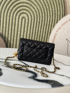 Quilted Chanel black shoulder bag with gold-tone CC emblem and chain strap