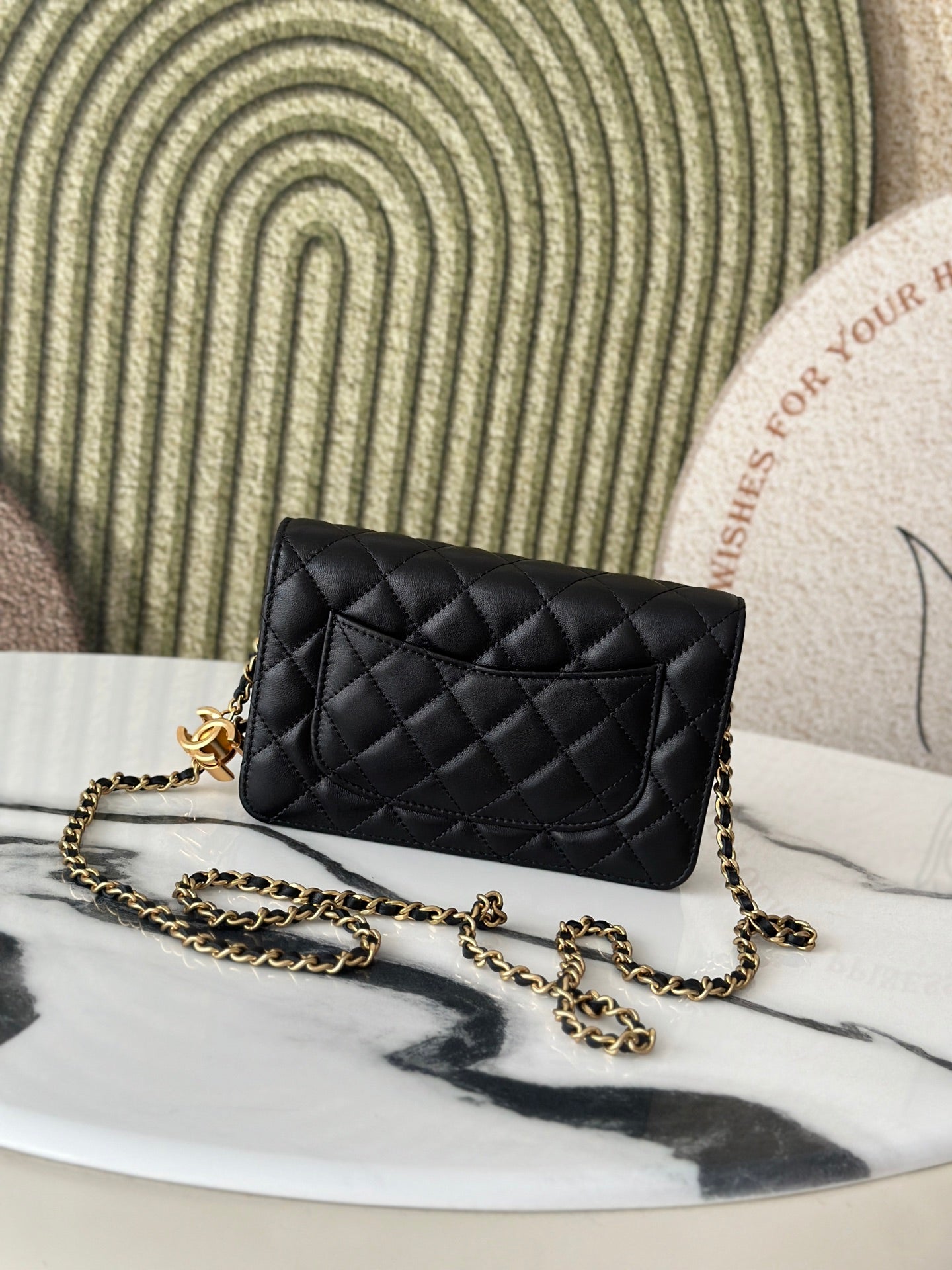 Quilted Chanel black shoulder bag with gold-tone CC emblem and chain strap