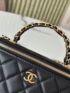 Chanel mini bag close-up of gold zipper and Chanel logo on quilted black leather