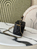 Chanel quilted mini bag side view with gold chain strap and zip top, black