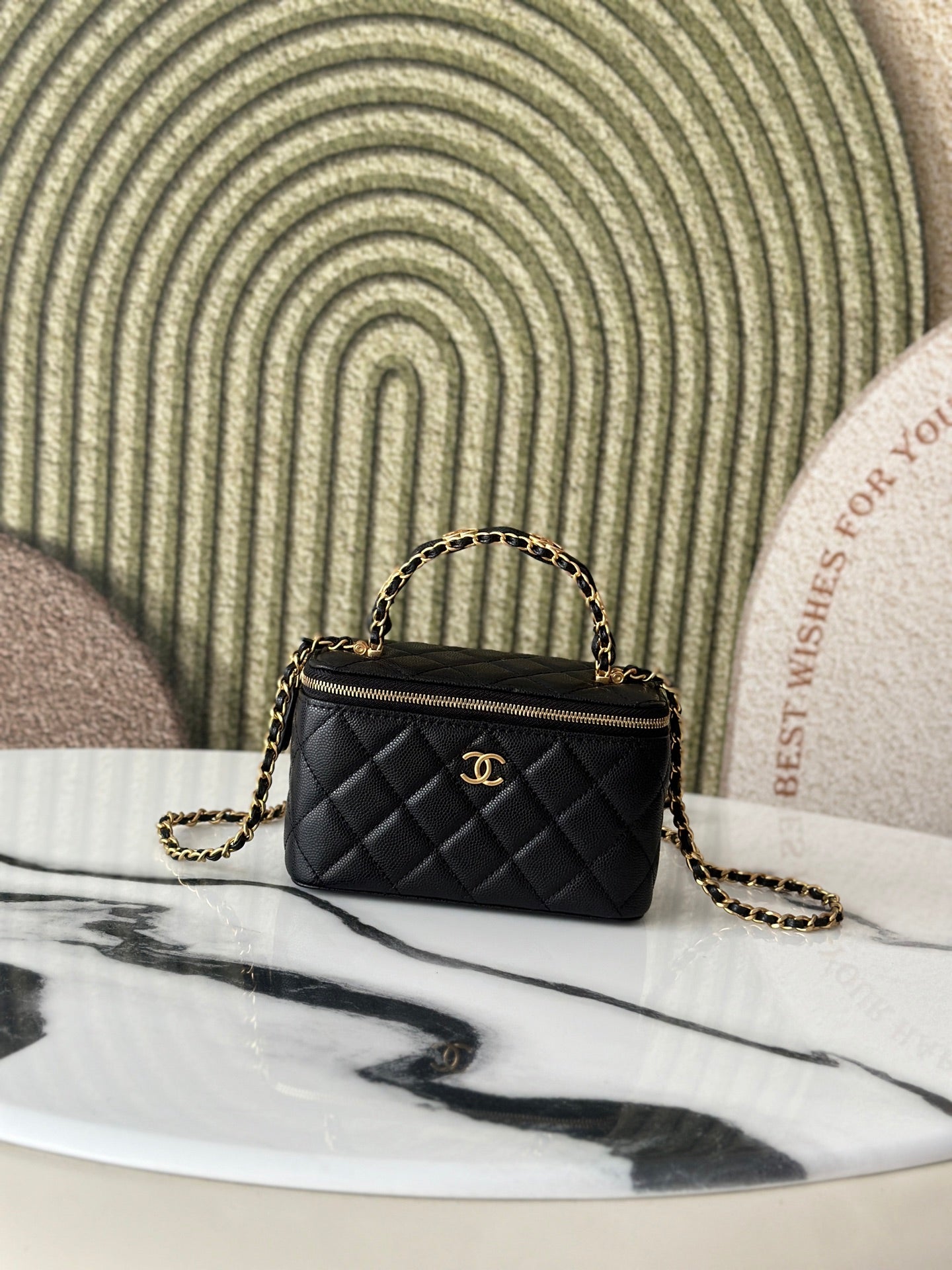 Chanel quilted mini bag with top handle and gold chain strap, black exterior