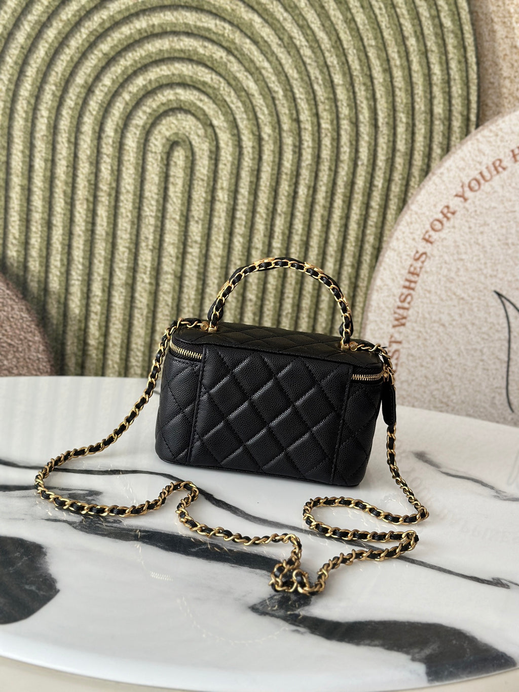 Chanel quilted mini bag with gold chain strap and top handle, black leather