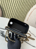 Chanel mini bag open top with interior lining visible, black leather and gold trim