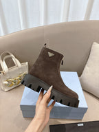 Prada ladies ankle boots, dark brown suede with front logo patch and lug sole.