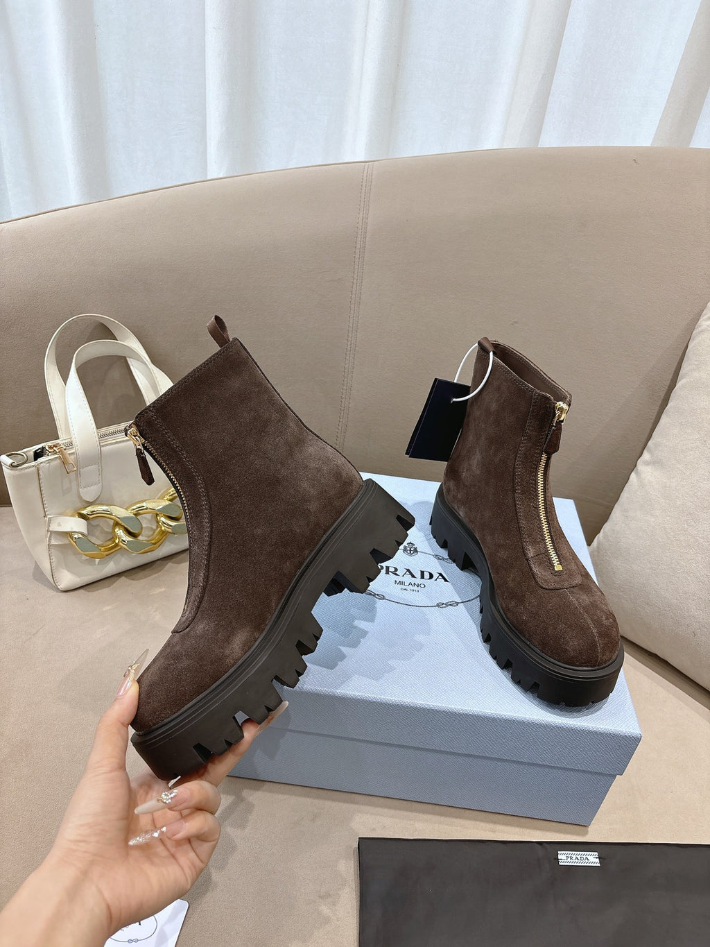 Prada ladies ankle boots, dark brown suede with side zip, lug sole, attached tag.