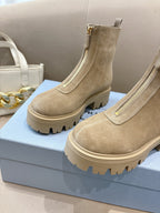 Beige suede Chelsea ankle boots with lug tread sole, side elastic gore, and pull tabs