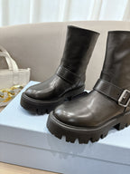 Prada ladies black leather mid-calf boots with wraparound strap and lug sole