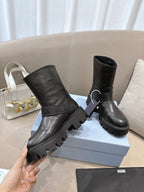 Prada ladies black leather mid-calf boots, one hand holding, buckle strap, lug sole