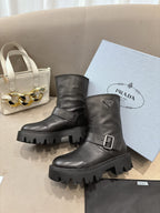 Prada ladies black leather boots with buckle strap and rugged lug sole