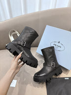 Prada ladies black leather mid-calf boots with buckle strap and lug sole