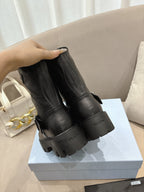 Prada ladies black leather mid-calf boots with pull-on back detail and lug sole