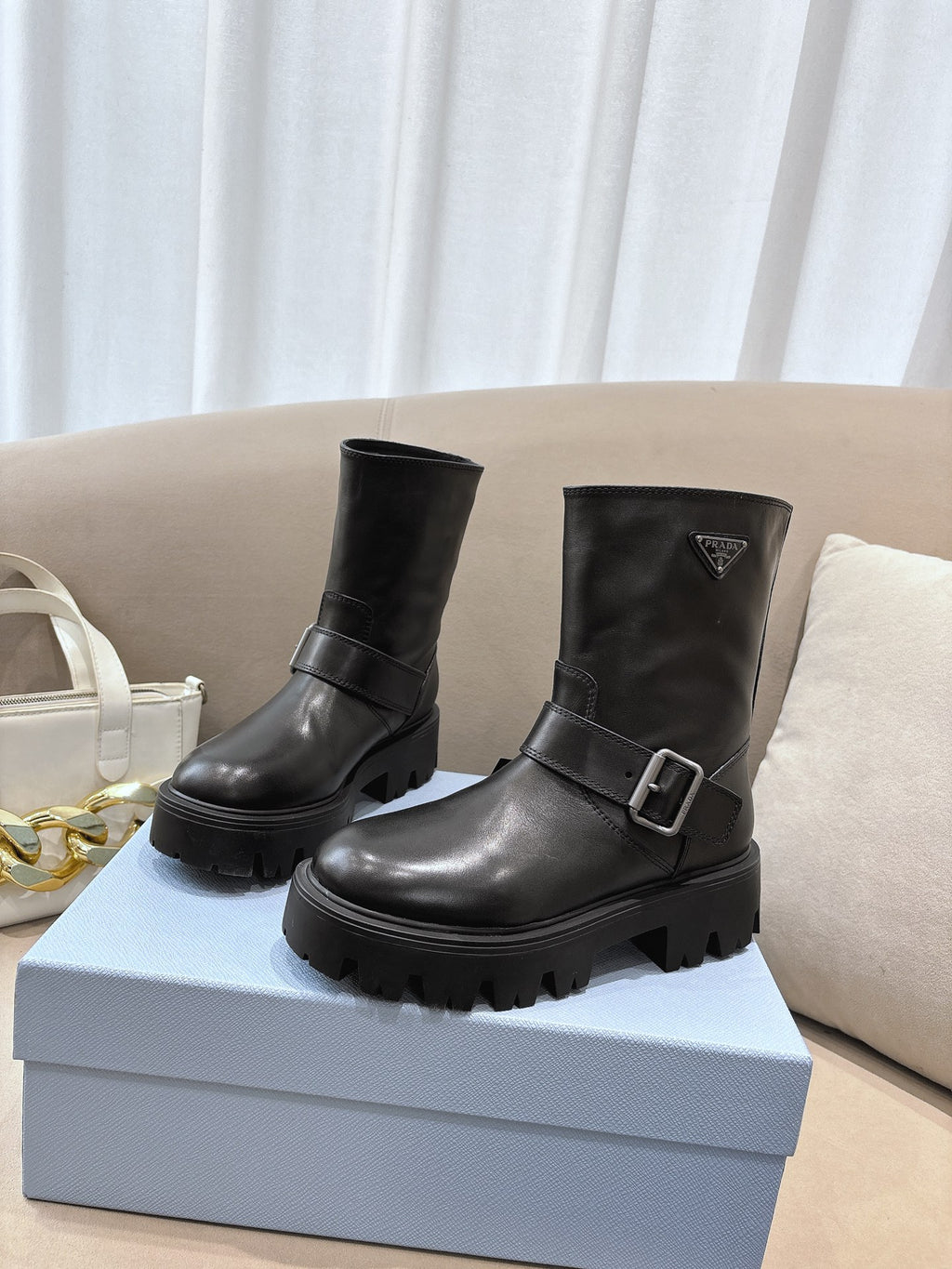 Prada ladies black leather ankle boots with side buckle and chunky lug sole