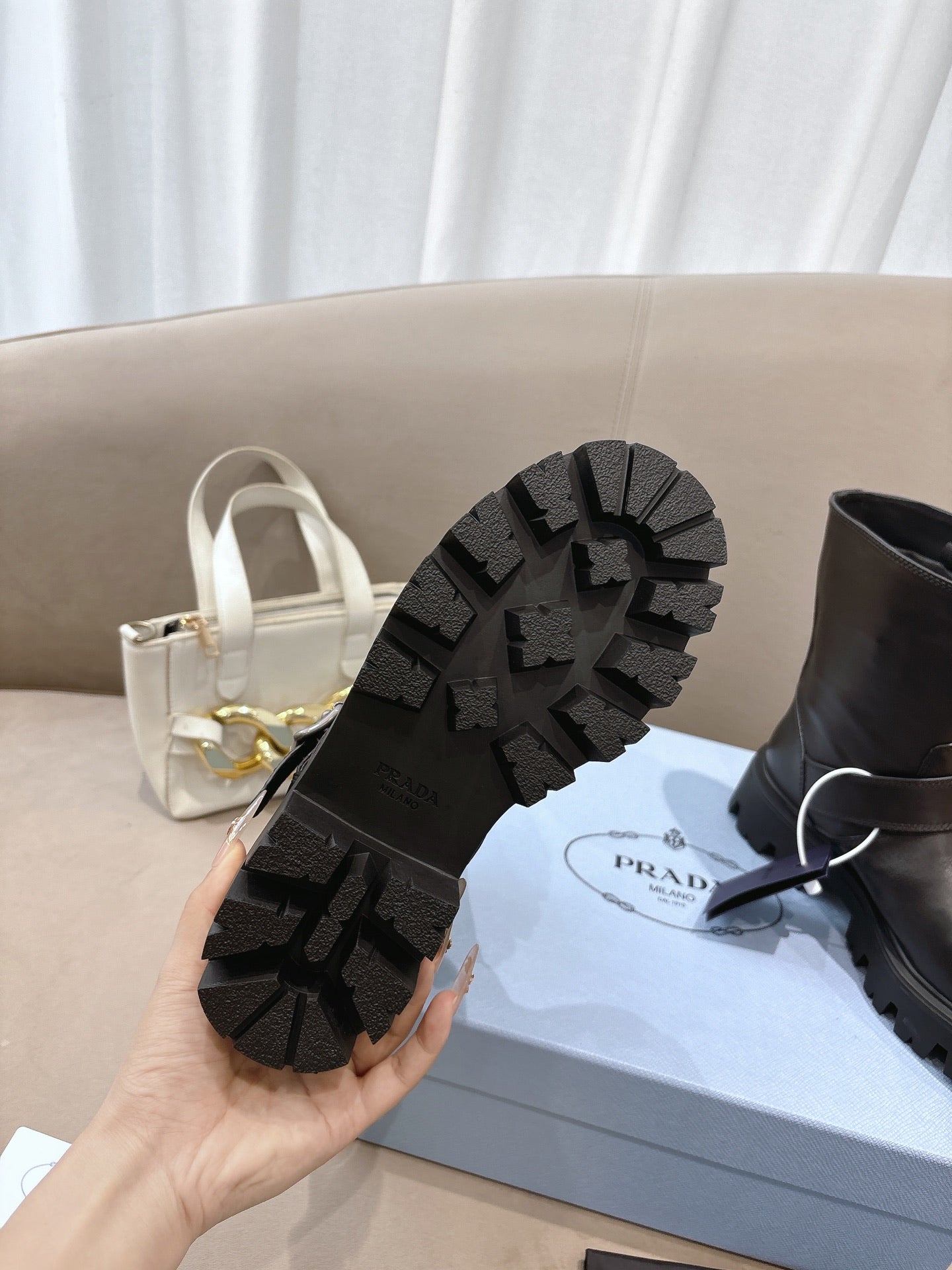 Prada ladies boot outsole with rugged lug tread on black sole