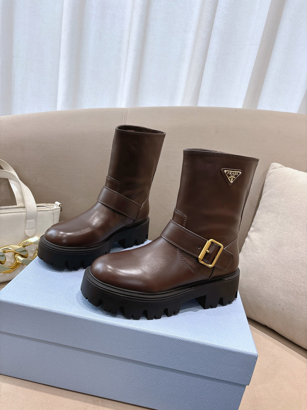 Prada ladies ankle boots, dark brown leather, gold-tone buckle, chunky tread sole