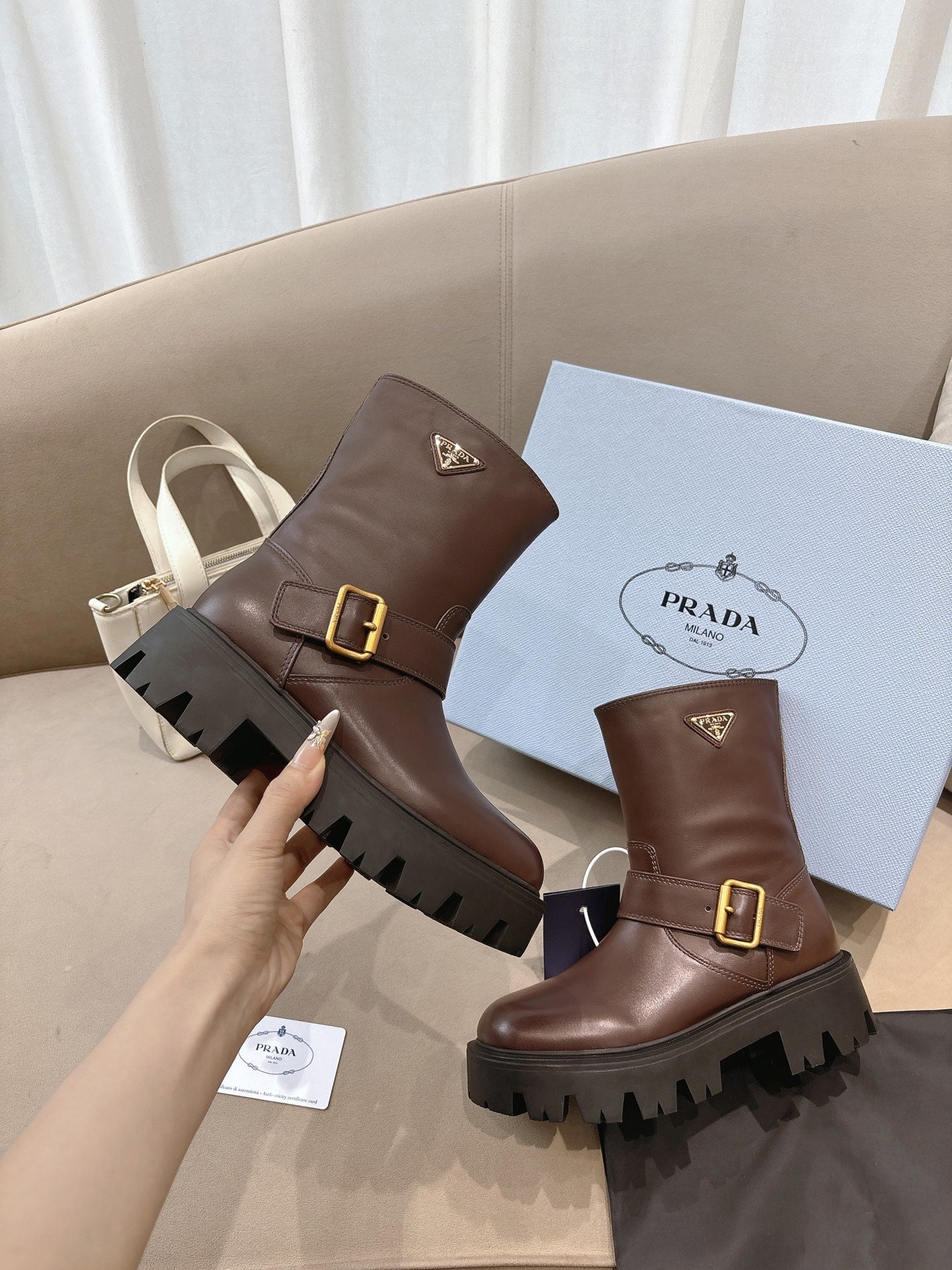 Prada ladies ankle boots, dark brown leather, gold buckle, rugged rubber lug sole
