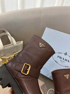 Prada ladies ankle boots close-up, dark brown leather with gold buckle and logo triangle