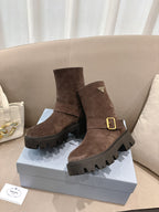 Brown suede ankle boots with gold buckle, side strap, and rugged lug sole