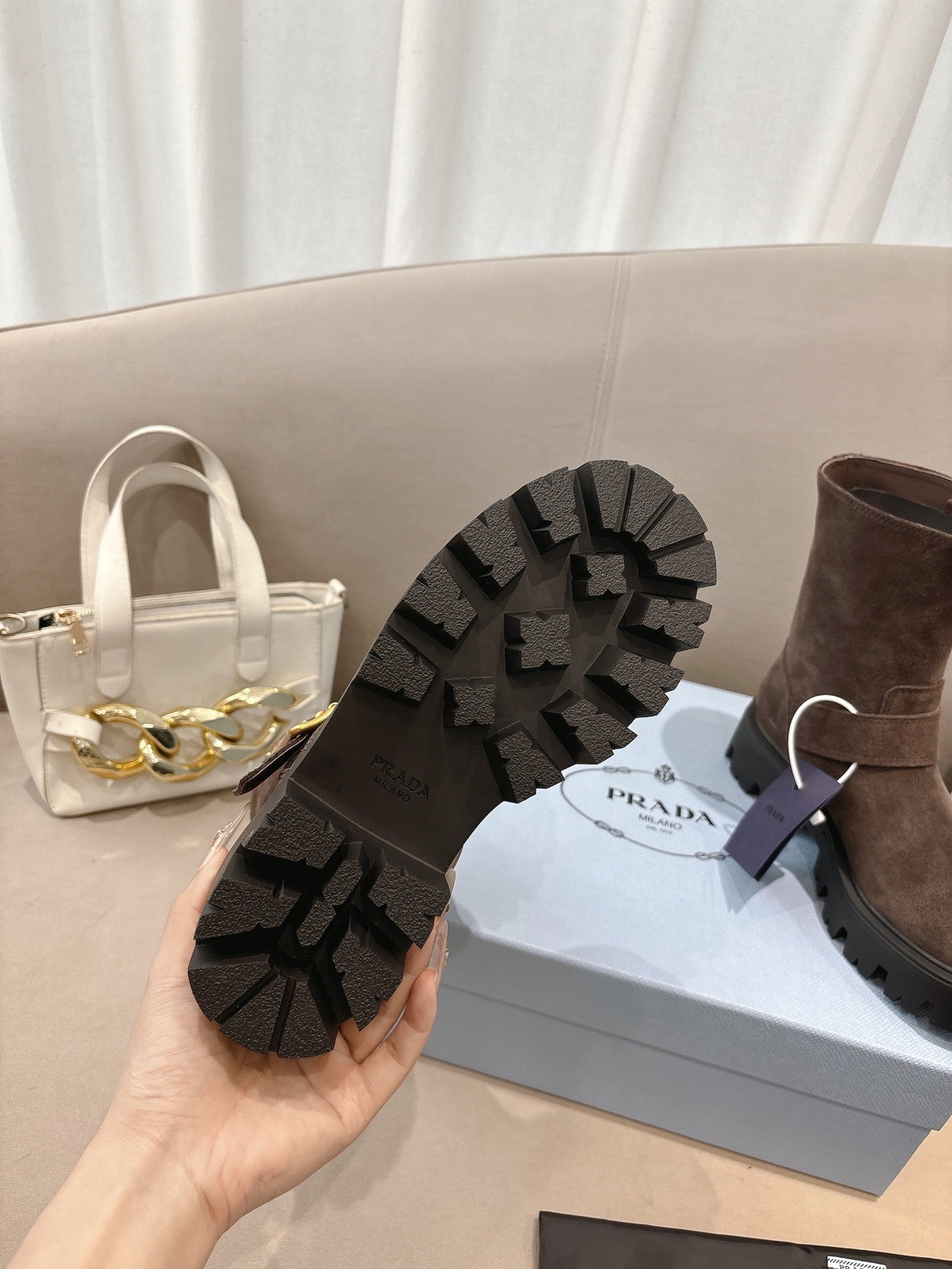 Brown suede ankle boots with black lug outsole tread visible