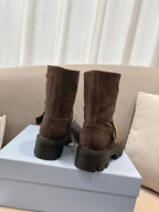 Brown suede ankle boots with pull tabs and thick lug soles, heel view