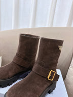 Brown suede ankle boots with gold buckle and triangular logo patch detail
