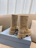 Prada women's suede ankle boots, beige, two-pair view with buckle accents and lug soles.