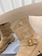 Prada women's suede ankle boots, beige, angled view showing gold-tone buckle and lug sole.