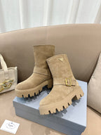 Prada women's suede ankle boots, beige, with front buckle strap and rugged platform sole.